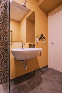 a white sink in a bathroom with a mirror at La Smorfia in Naples +66 photos