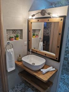 a bathroom with a white sink and a mirror at Kalderimi Studio in Sotír