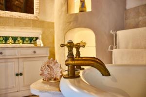 a bathroom sink with a gold faucet on it at Gilcrest Place Guest House in Paternoster