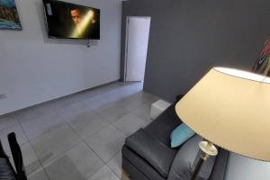 a living room with a couch and a television at Departamento de Categoria Torre Costanera Norte, Corrientes in Corrientes