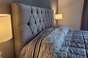 a bedroom with a bed with a blue comforter at Departamento de Categoria Torre Costanera Norte, Corrientes in Corrientes