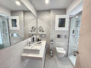 a bathroom with a sink and a shower and a toilet at Diamante Paguera Boutique Hotel in Paguera