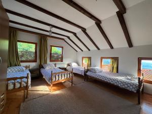 a room with beds and windows in a house at Villa White Dove Sarajevo in Sarajevo