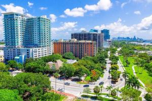 a city with tall buildings and a street with trees at Relaxing Condo Hotel In The Grove, Free Parking in Miami