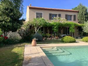 a house with a swimming pool in front of it at Mas des Oliviers in Martigues