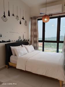 a bedroom with a white bed with a large window at KLIA AIRPORT HOMESTAY 3 in Sepang