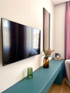 a large flat screen tv hanging on a wall at Lux City Apartments & Rooms in Sarajevo