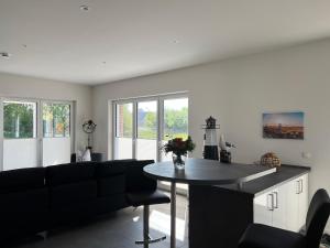 a living room with a black couch and a table at Ferienhaus RELAX in Büsum