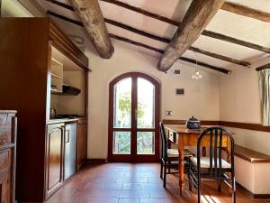 a kitchen with a table and a table and a window at L'Aiolina in Vagliagli