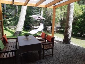 a table and chairs with an umbrella on a patio at domki apartamenty Nasza Chata - 4 minuty od plaży in Pobierowo