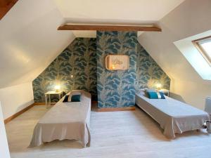 a room with two beds in a attic at Les écuries à 12 mn de Cabourg in Goustranville