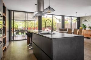 a kitchen with a large island with a counter top at Villa avec Piscine - 15 ' JO - Vélos - 30 ' Disney in Saint-Maur-des-Fossés