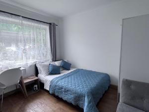 a small bedroom with a bed and a window at Number 25 in Horley