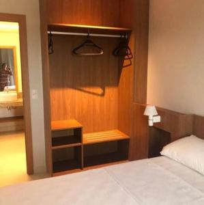 a bedroom with a bed and a closet and a mirror at Salinas Exclusive Resort in Salinópolis +4 photos