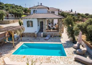 a villa with a swimming pool in front of a house at Villa Luna in Kavála
