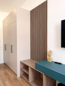 a room with a blue table and a television at Lux City Apartments & Rooms in Sarajevo