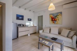 a living room with a couch and a table at The Gallery Home in Antiparos