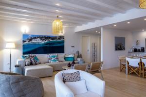 a living room with a couch and a table at The Gallery Home in Antiparos