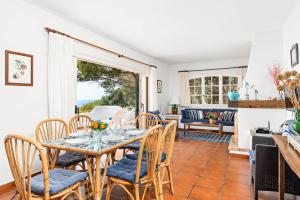 a dining room with a table and chairs at Vista Mar in Cala Galdana
