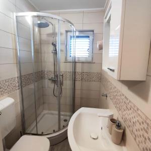 a bathroom with a shower and a toilet and a sink at New apartments Kunić Sobra-Mljet in Sobra +26 photos