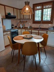 a kitchen with a table and chairs in a kitchen at ZeusPlace Olympus Olive Country House 1 in Leptokarya