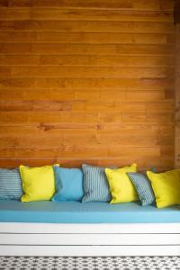 a row of colorful pillows sitting on a blue couch at Bungalow La Coulée d'Or in Le Vauclin