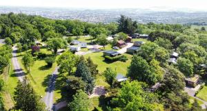 an aerial view of a home with trees and a road at Hotel De Plein Air Le Chanset in Ceyrat