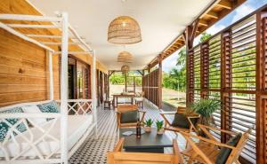 a porch of a house with wooden walls at Villa La Coulée d'Or in Le Vauclin