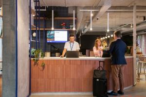 a group of people standing at a counter at ibis budget Gent Centrum Dampoort in Ghent