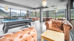 a billiard room with couches and a pool table at Hotel Memoir Kazbegi by DNT Group in Kazbegi