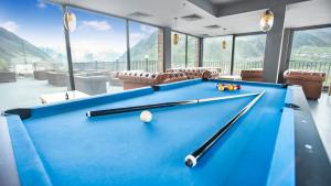 a pool table in a room with a pool ball at Hotel Memoir Kazbegi by DNT Group in Stepantsminda
