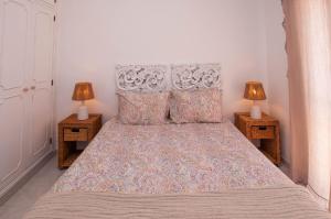 a bedroom with a large bed with two night stands at Waves by OCvillas in Albufeira +26 photos