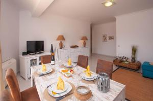 a dining room with a table with food on it at Waves by OCvillas in Albufeira