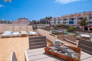 a balcony with a table and chairs on a roof at Waves by OCvillas in Albufeira