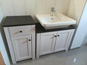 a bathroom with a white sink and a white cabinet at Rare find! Dogs Welcome Secluded Comfy House Krk in Šilo +28 photos