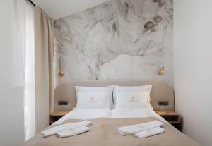 a bedroom with a bed with two towels on it at Villa La Meravigliosa in Vodice +66 photos