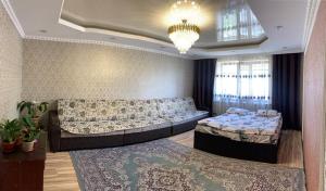 a living room with two beds and a couch at KF_Guest House-Madina in Shabdan