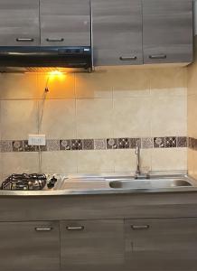 a kitchen with a sink and a stove at Linving buenos aires in Medellín