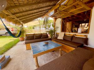 a living room with a couch and a table at Emuna Guest house in Puerto Escondido