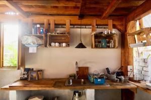 a kitchen with a wooden counter top and a sink at Emuna Guest house in Puerto Escondido