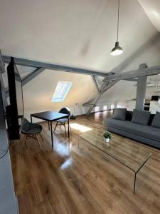 a living room with a couch and a table at T-Apartments in Marktheidenfeld