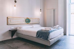 a bedroom with a bed with two towels on it at La Smorfia in Naples
