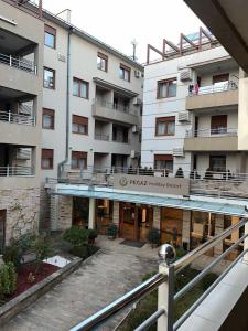 a large white building with a hotel entrance at Apartman Nada de lux in Vrnjačka Banja