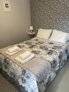 um quarto com uma cama com duas toalhas em Liber Guest House em Braga