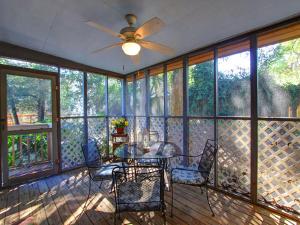 a screened in porch with a table and chairs at Donna`s Escape in Tybee Island