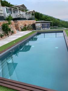 Biaza的住宿－LE TERRAZZE SUL GARDA RELAIS，房屋前方的大型蓝色海水游泳池