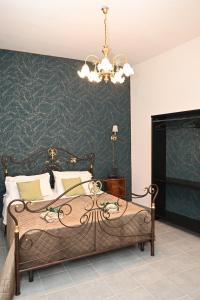 a bedroom with a bed with a chandelier at B&B Carlo V - House Hotel in Capua