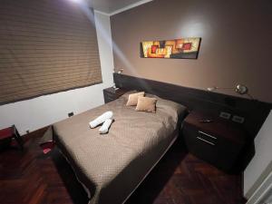 Säng eller sängar i ett rum på Departamento Avenida Bicentenario