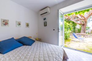 アナカプリにあるVilla delle Ninfee by Napoliapartmentsのベッドと大きな窓のある寝室