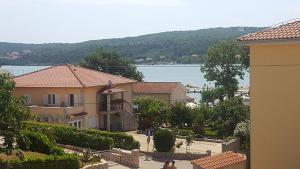 a view of a house with a view of the water at Apartment Cizici ,Best Place 100m zum Meer, Soline bay, insel-krk,de in Čižići